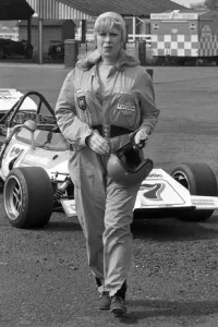 Roberta Cowell Standing in her Race Car Outfit