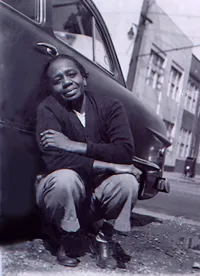 Ruth Ellis Crouching in Front of Car