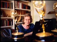 Angela Morley Sitting at her Piano With her Emmy's