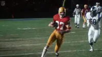 Jerry Smith Running With Football During a Game