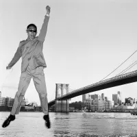 Tseng Kwong Chi at the Brooklyn Bridge in 1979 From East Meets West