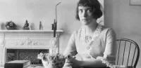 Katherine Mansfield Sitting at a Table