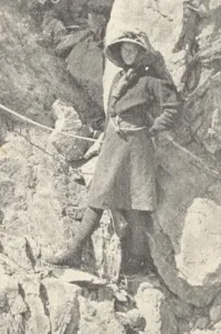 Freda Du Faur Resting on a Rock During a Climb