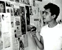 Sal Mineo Looking at News Clippings on a Wall