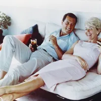 Rock Hudson and Doris Day Relaxing on a Couch in the 1960s