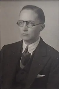 Portrait of Dr. Hart in Business Suit wearing Glasses.