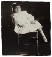 Frida Kahlo at Five Years Old Sitting on a Chair in a Dress