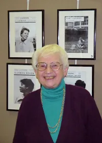 Kay Lahusen Stands in Front of Her The Ladder Magazine Covers