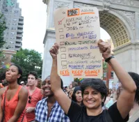 Urvashi Vaid at the 2011 New York City Dyke March Holding up Dyke Agenda Checklist Sign