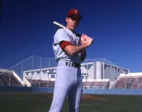 Billy Bean in his Loyola Marymount University Baseball Uniform on the Field Holding a Baseball Bat
