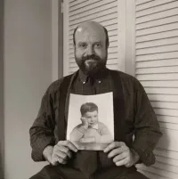 Arnie Kantrowitz Holding a Picture of Himself as a Child