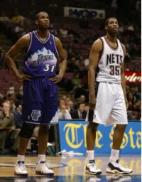 Jarron and Jason Collins in Their Uniforms on the Basketball Court Playing Against Each Other